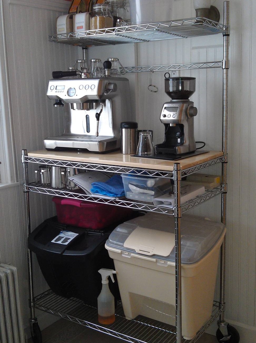 chrome bakers rack set up as a coffee bar holding an espresso machine and accessories